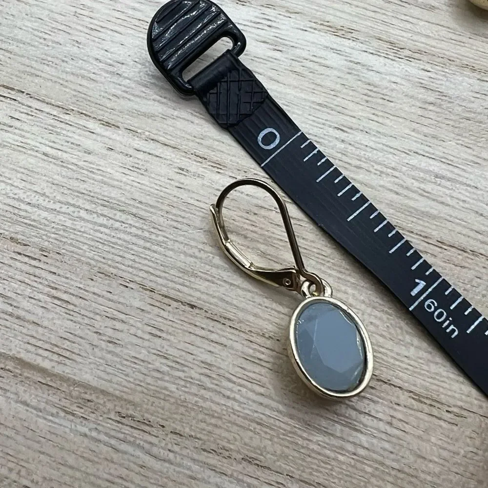 Faceted blue grey hinge dangle earrings on gold tone backing